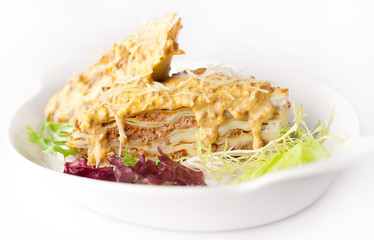 lasagna with yellow sauce and parmesan cheese
