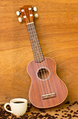 Obraz premium Coffee and Ukulele on wood background