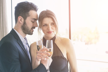 Elegant Young Couple Cheering at Hotel Suite
