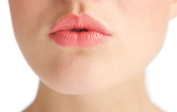 Beautiful young woman with kissing lips