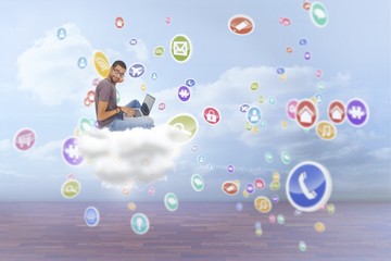 Composite image of man wearing glasses sitting using laptop and