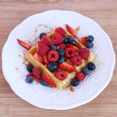 Belgian waffle with berries and syrup
