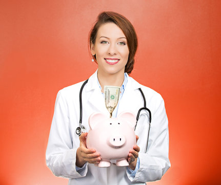 Closeup Portrait Female Doctor Holding Piggy Bank, Savings