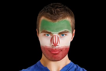 Composite image of serious young iran fan with facepaint