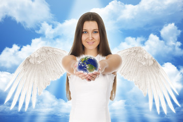 beautiful young angel woman holding Earth in hands with clouds