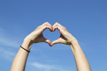 I love you - woman showing heart sign with her hands