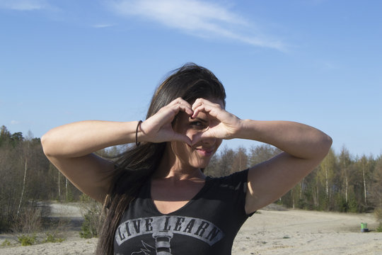 I love you - woman showing heart sign with her hands