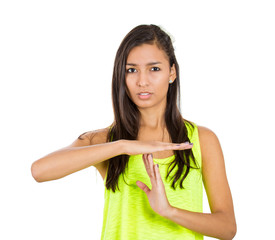 Young woman giving time out gesture, asking to pause