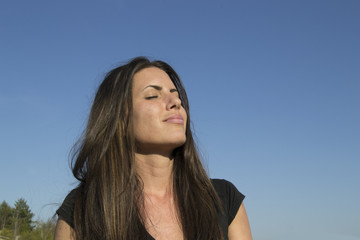 Satisfied woman in the evening sun - meditation