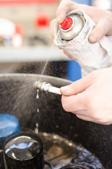 Spark plug cleaning in repair shop.