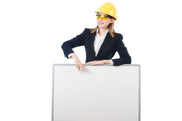 Young businesswoman with hard hat with blank board isolated on w
