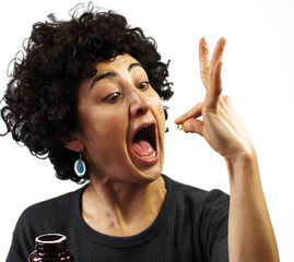 Woman swallows a pill