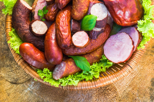 Various meat sausage basket wooden table background