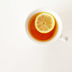 White cup of tea with lemon