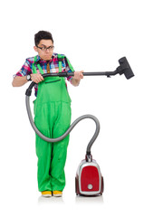 Funny man in green coveralls vacuum cleaning