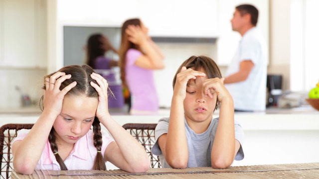 Sad children listening to their parents fighting