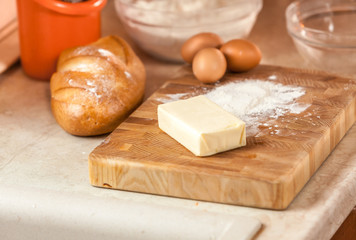 photo of butter, eggs, and flour lying on wooden board