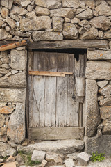 Fototapeta na wymiar Old wood door and stone wall