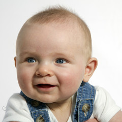 happy 6 months old sitting and smiling