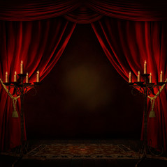 room with red curtains and candles