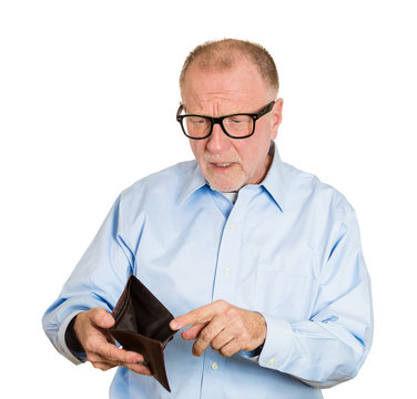 Sad, gloomy, surprised elderly man holding empty wallet
