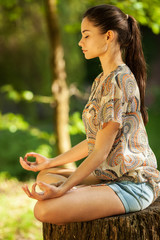 Young female meditate in nature