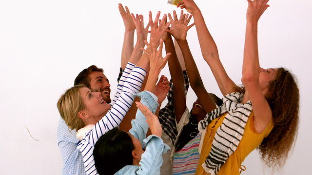 Young people throwing money on white background