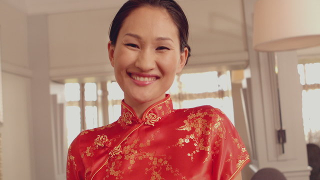 Asian waitress smiling at camera