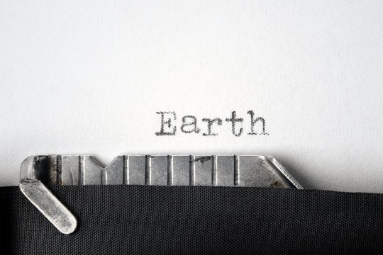"Earth" written on an old typewriter. Closeup.