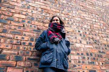 Model wearing tartan scarf, barbour style jacket,