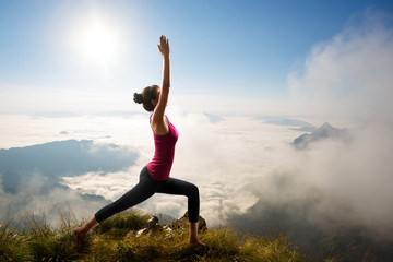 Fototapeta na wymiar Young woman exercises yoga