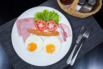 American breakfast with eggs ham bacon and sausage