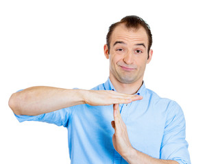 Young business man showing time out hand gesture on white 