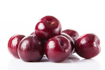 plums isolated on white