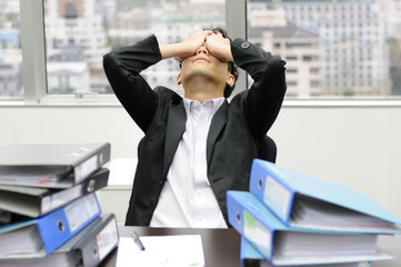 Thoughtful or stressful businessman at work