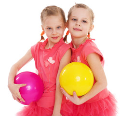 Fototapeta na wymiar Two young girl gymnast with sports balls.