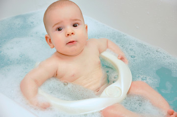 Baby take shower bath in bath seat