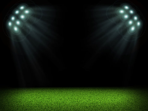 Night football arena illuminated by spotlights