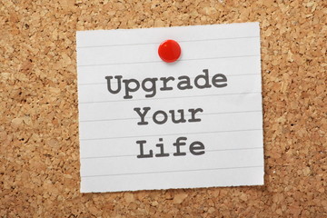 Upgrade Your Life reminder on a cork notice board