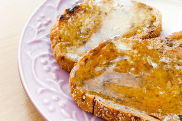 Pieces of toasts with honey and butter.Morning healthy breakfast