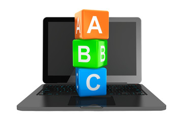 Online Education Concept. Modern Laptop with ABC toy cubes