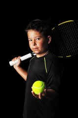 Portrait of handsome boy with tennis equipment