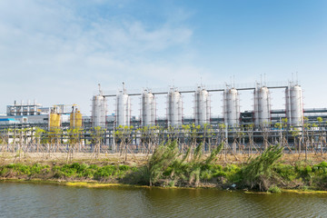 coal fired power station with cooling towers releasing steam int