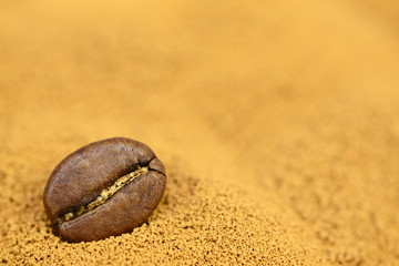 Fototapeta na wymiar golden instant coffee background with coffee bean