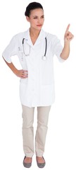 Fototapeta premium Pretty brown haired nurse pointing