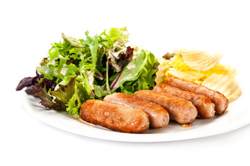 Grilled sausages  vegetables and chips