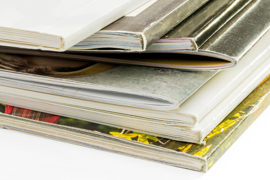 A pile of different catalogs on white background