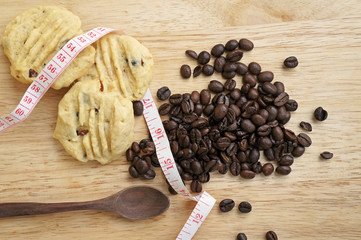 Low fat cookies on wooden table with coffee beans