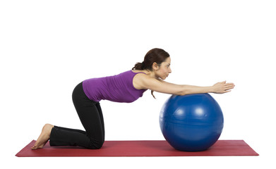 Woman working out her arms with a pilates ball