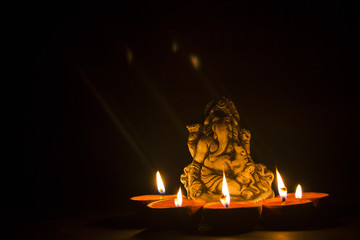 lord ganesha with oil lamp